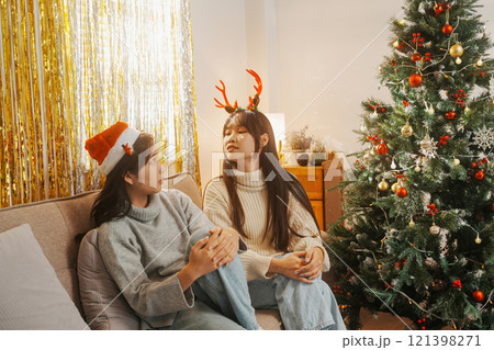 Two friends decorated Christmas tree at home. Two friends decorated Christmas tree at home. 121398271