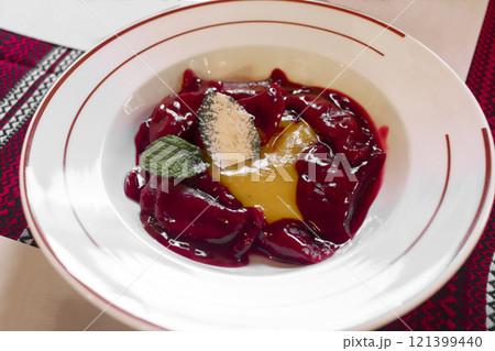 Cherry dumplings with spicy yellow sweet sauce. Traditional Ukrainian food. 121399440