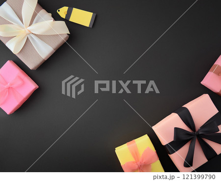 Gift boxes on black paper background with copy space. AI Generated. 121399790