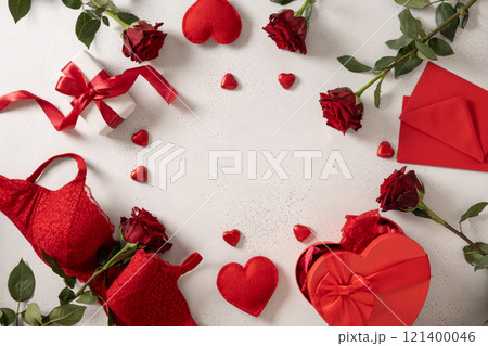 Valentine's day frame with red lace bustier underwear, gifts, candy sweets and red roses on white background. Love. View from above. Copy space. Romantic dating. 121400046