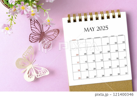 May 2025 desk calendar for the organizer to plan and reminder and paer butterfly on pink background. 121400346