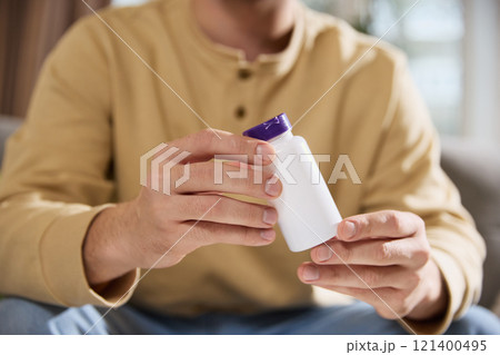 Man holding jar with empty space, filled with vitamins, dietary supplements for health. Strengthening immune system. 121400495