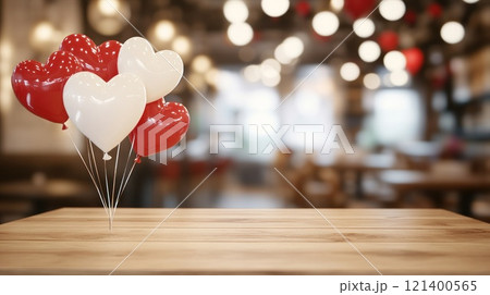 Empty wooden tabletop and heart shaped balloons on blurred cafe background. Valentine's day concept 121400565