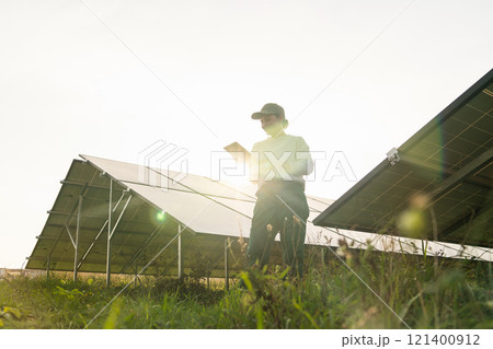 Female farmer with digital tablet on a modern farm using solar panels. Female farmer with digital tablet on a modern farm using solar panels. 121400912