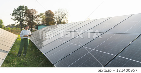 Female farmer with digital tablet on a modern farm using solar panels. Female farmer with digital tablet on a modern farm using solar panels. 121400957
