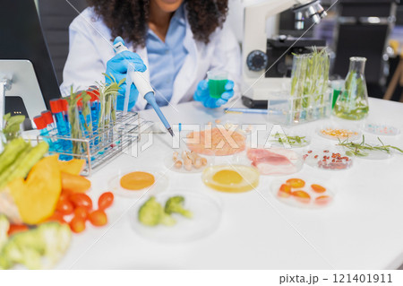 Microbiologists and nutrition experts analyze molecular samples in advanced food science labs, exploring innovations in nutrition, psychiatry, and health science research. 121401911
