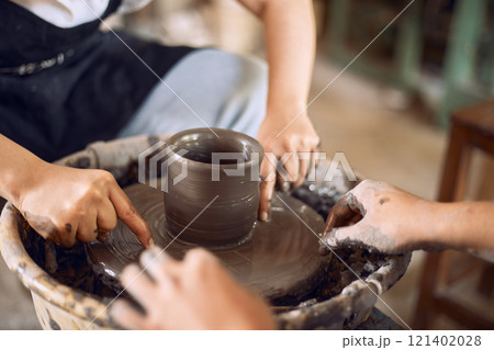 Hands of craftsman artist working on pottery wheel. Hands of craftsman artist working on pottery wheel. 121402028