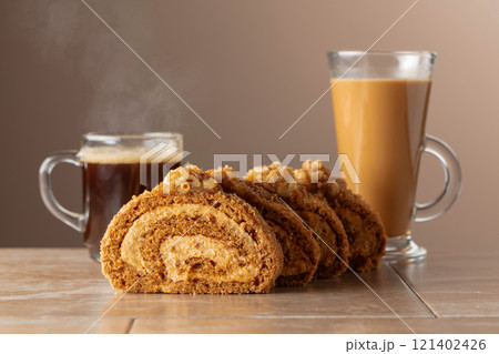 Dessert with walnuts and coffee on a beige background. 121402426