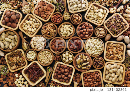 Colorful mix of various nuts: peanut and cashew, hazelnut and almond, pine nuts and walnut; healthy diet snack; vegan food background 121402861