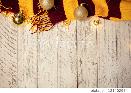 White wooden Christmas background. Empty space for text. Happy New Year. Christmas balls, garland, brown-red scarf. White wooden Christmas background. Empty space for text. Happy New Year. Christmas balls, garland, brown-red scarf. 121402954