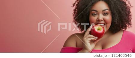 Happy plus size model eating red apple promoting healthy diet Happy plus size model eating red apple promoting healthy diet 121403546