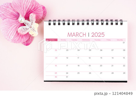 Desk calendar for March 2025 with pink orchid. 121404849