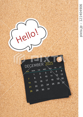 December 2025 Black calendar page and Hello text with thumbtack on board. December 2025 Black calendar page and Hello text with thumbtack on board. 121404906