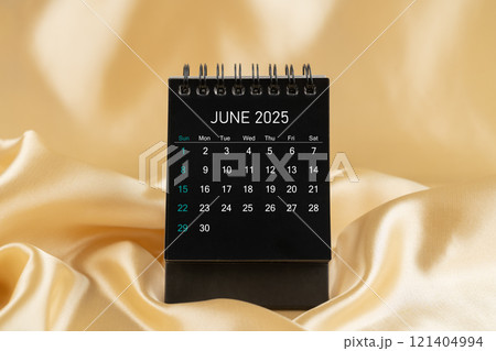 June Desk mini desk calendar black color for 2025 year on gold color silk. June Desk mini desk calendar black color for 2025 year on gold color silk. 121404994
