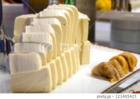 Melted Cheese Slices with Figs on a Tray - Close-Up, Restaurant Menu Melted Cheese Slices with Figs on a Tray - Close-Up, Restaurant Menu 121405423