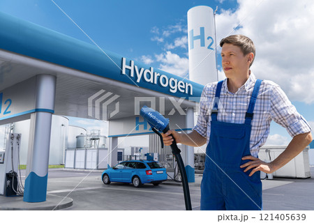 Man holds a hydrogen fueling nozzle. Refueling car with hydrogen fuel. 121405639