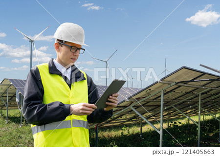 Engineer with digital tablet on a backround of solar panels 121405663