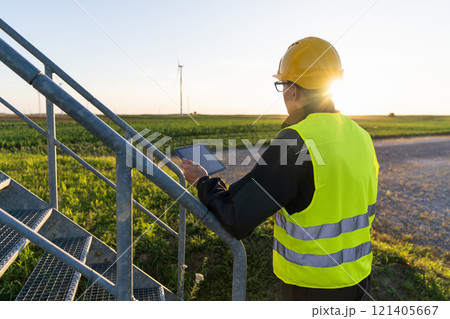 Engineer with digital tablet controls wind turbines Engineer with digital tablet controls wind turbines 121405667
