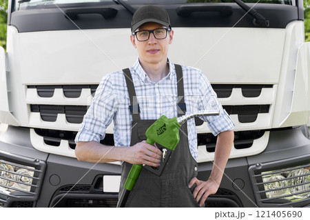 Man with biofuel filling nozzle on a background of truck Man with biofuel filling nozzle on a background of truck 121405690