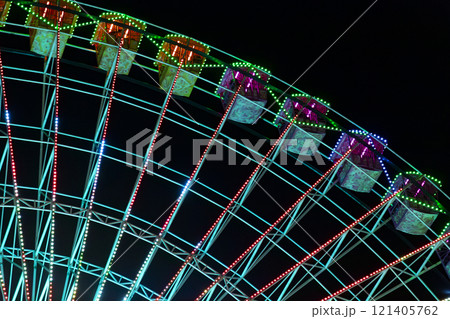 Ferris wheel. Noria. Christmas lights in Vigo, Pontevedra. Christmas decorations. Tourists strolling through its streets. Ferris wheel in the dark showing neon colors. VIGO. SPAIN. 23 December 2024. 121405762