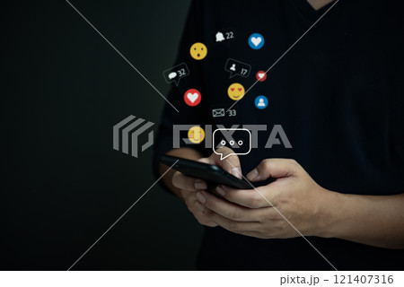 Person holding a smartphone with social media icons floating, representing digital engagement, communication, and social interaction. Person holding a smartphone with social media icons floating, representing digital engagement, communication, and social interaction. 121407316