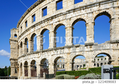 Facade of the ancient ruins of one of the largest preserved Roman amphitheaters in Pula, Istria 121409083