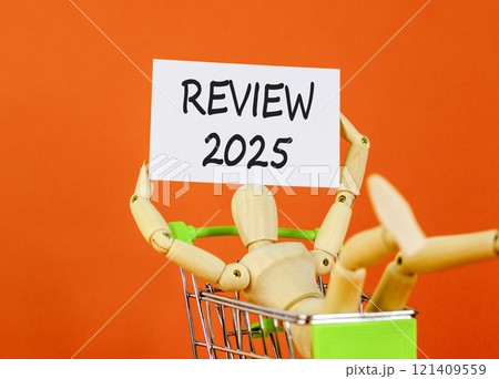 Planning review 2025 new year symbol. Concept words Review 2025 on beautiful white paper on wooden clothespin. Beautiful orange background. Business review 2025 new year concept. Copy space. Planning review 2025 new year symbol. Concept words Review 2025 on beautiful white paper on wooden clothespin. Beautiful orange background. Business review 2025 new year concept. Copy space. 121409559