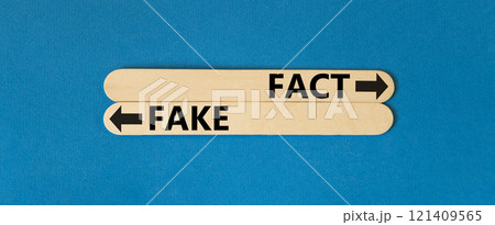 Fact or fake symbol. Concept word Fake and Fact on beautiful wooden stick. Beautiful blue table blue background. Business and fact or fake concept. Copy space. Fact or fake symbol. Concept word Fake and Fact on beautiful wooden stick. Beautiful blue table blue background. Business and fact or fake concept. Copy space. 121409565