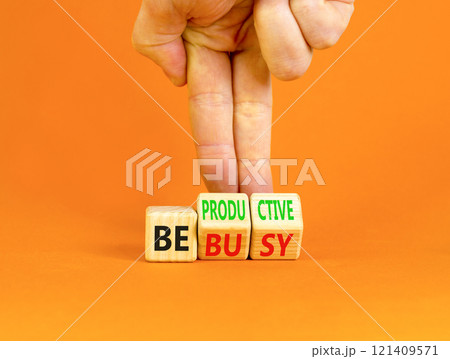 Be productive not busy symbol. Concept words Be productive Be busy on wooden block. Beautiful orange table orange background. Businessman hand. Business be productive not busy concept. Copy space. 121409571