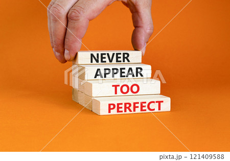 Never appear too perfect symbol. Concept words Never appear too perfect on beautiful wooden blocks. Beautiful orange table orange background. Business and never appear too perfect concept. Copy space. 121409588