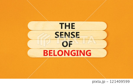 The sense of belonging symbol. Concept words The sense of belonging on beautiful wooden sticks. Beautiful orange table orange background. Business and the sense of belonging concept. Copy space. 121409599