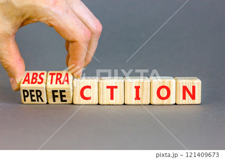 Perfection or abstraction symbol. Concept words Perfection Abstraction on beautiful wooden blocks. Beautiful grey background. Businessman hand. Business perfection or abstraction concept. Copy space Perfection or abstraction symbol. Concept words Perfection Abstraction on beautiful wooden blocks. Beautiful grey background. Businessman hand. Business perfection or abstraction concept. Copy space 121409673
