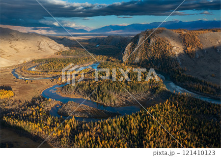 Aerial view of scenic river valley surrounded by autumnal forest and mountains 121410123