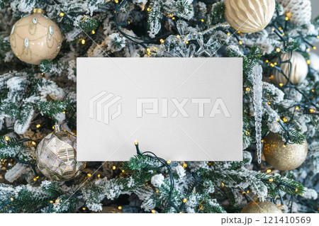 White blank paper rectangle on festive decorated Christmas tree showy branches background 121410569