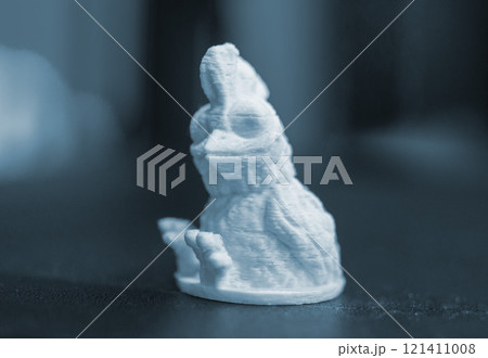 Art object printed on 3D printer from white melted plastic close-up. White model created on 3D printer from plastic. 3D Printing technology. Additive progressive technology. New modern technologies Art object printed on 3D printer from white melted plastic close-up. White model created on 3D printer from plastic. 3D Printing technology. Additive progressive technology. New modern technologies 121411008