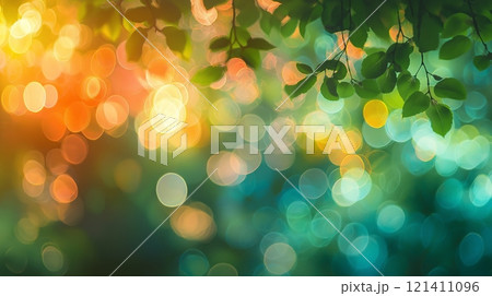 Colorful bokeh with green leaves creating a dreamy atmosphere in nature Colorful bokeh with green leaves creating a dreamy atmosphere in nature 121411096