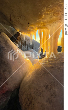Sea rocks covered with ice. Huge icicles from the sea wave Sea rocks covered with ice. Huge icicles from the sea wave 121411429
