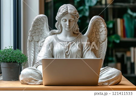 Angel statue sits at a desk with a modern laptop, surrounded by greenery and natural light. Angel statue sits at a desk with a modern laptop, surrounded by greenery and natural light. 121411533