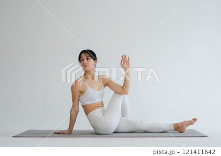 Yoga fitness workout training. Woman practicing yoga isolated on white background. Woman doing sports exercise on yoga mat. Girl in sportswear have training workout for weight loss. Sport and fitness 121411642