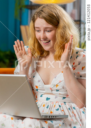 Amazed young woman use laptop computer, receive good news message, shocked by victory, celebrate win Amazed young woman use laptop computer, receive good news message, shocked by victory, celebrate win 121412058