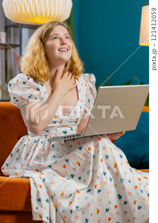 Amazed young woman use laptop computer, receive good news message, shocked by victory, celebrate win Amazed young woman use laptop computer, receive good news message, shocked by victory, celebrate win 121412059