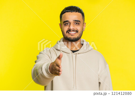 Indian young man outstretching hand to camera, offering handshake, greeting, invitation, welcoming 121412080