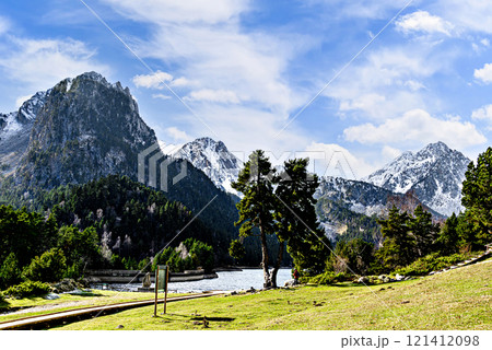 Image of Sant Maurici Lake with snow-capped mountains, in the Aigues Tortes National Park, in the Lleida Pyrenees, Catalonia, Spain Image of Sant Maurici Lake with snow-capped mountains, in the Aigues Tortes National Park, in the Lleida Pyrenees, Catalonia, Spain 121412098