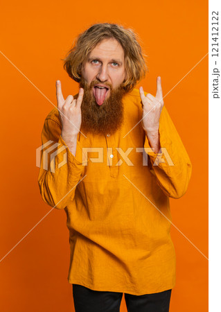 Happy joyful man showing rock n roll gesture by hands cool sign crazy expression dancing victory win 121412122