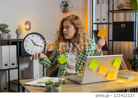 Tired businesswoman using laptop sticky notes with many tasks overworked checking time on clock 121412123