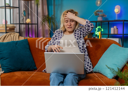 Sad woman using laptop notebook typing browsing working loses bad news game fail computer virus 121412144