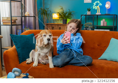 Upset child kid girl using smartphone playing game loses bad news fail education study test at home 121412156