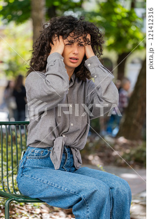 Displeased exhausted woman rubbing temples to cure headache problem suffering from tension migraine Displeased exhausted woman rubbing temples to cure headache problem suffering from tension migraine 121412316