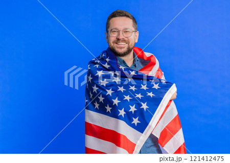 Man in glasses wrapped up in American USA flag, celebrating, human rights and freedoms, independence Man in glasses wrapped up in American USA flag, celebrating, human rights and freedoms, independence 121412475