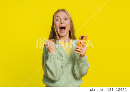 Happy excited winner woman use smartphone celebrating success winning play game good lottery news 121412482